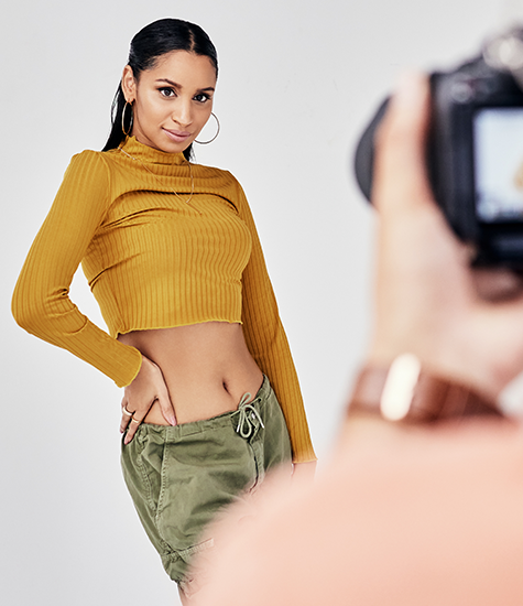 Model showcasing top during shoot Model posing for a photoshoot