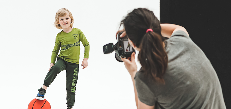 Young model during photoshoot session Child model posing with basketball